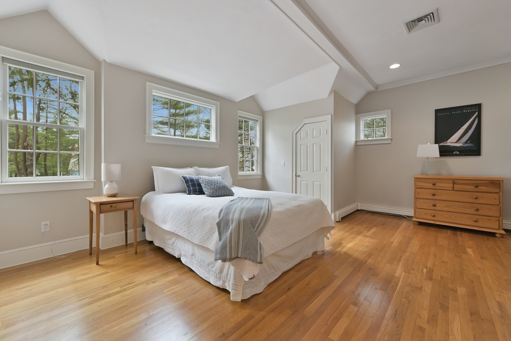 11 Olmsted Drive Hingham, MA 02043 - Photo 26 of 36 a spacious bedroom with a bed a dresser and wooden floor
