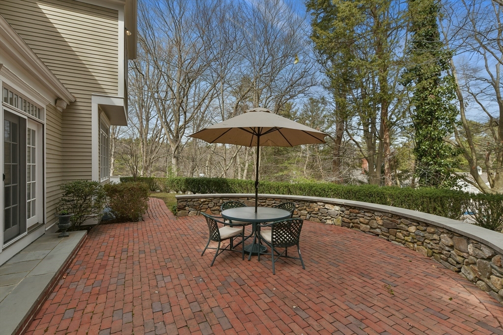 11 Olmsted Drive Hingham, MA 02043 - Photo 35 of 36 a patio with a table and chairs