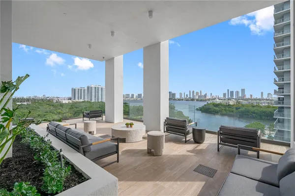 a terrace with outdoor seating city view and lake view