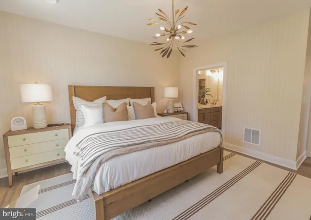 a bedroom with a bed and a chandelier