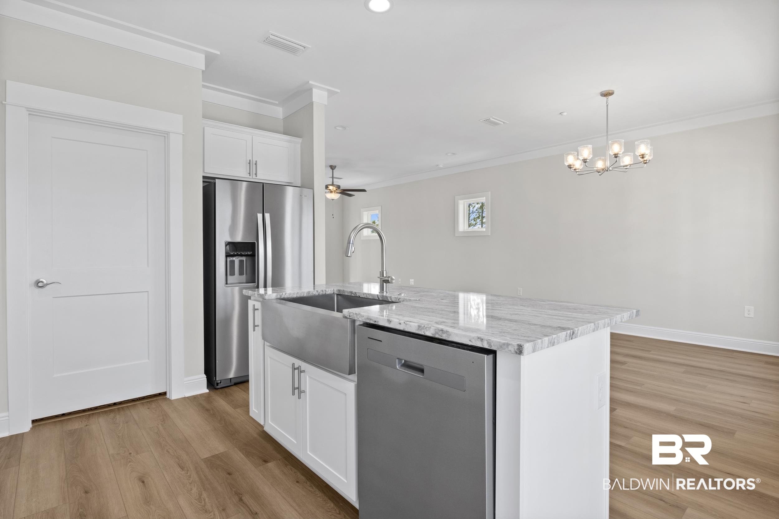 2847 Salt Drive Orange Beach, AL 36561 - Photo 11 of 29 Kitchen with white cabinetry, pendant lighting, an island with sink, and stainless steel appliances