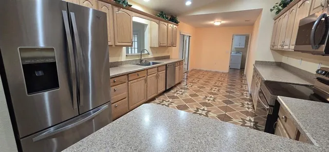 a kitchen with stainless steel appliances a refrigerator and a stove