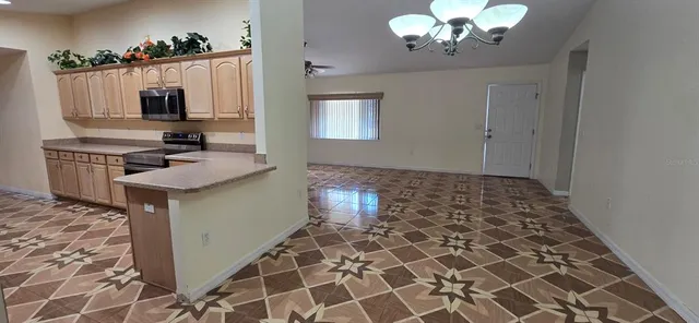 a kitchen with a sink a stove and cabinets