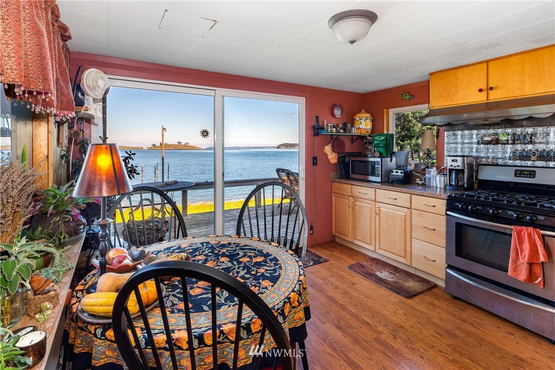 416 Lonesome Cove Road Friday Harbor, WA 98250 - Photo 17 of 40 a kitchen that has a lot of cabinets a sink and appliances in it