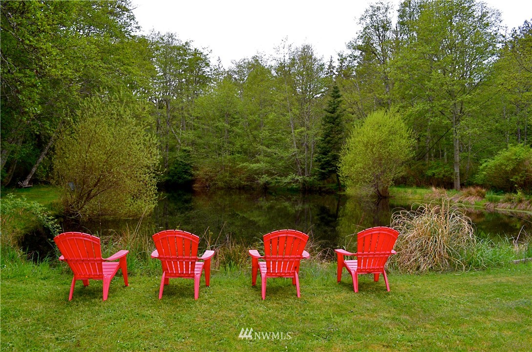 416 Lonesome Cove Road Friday Harbor, WA 98250 - Photo 25 of 40 a group of chairs sitting in a yard with swimming pool and lawn chairs