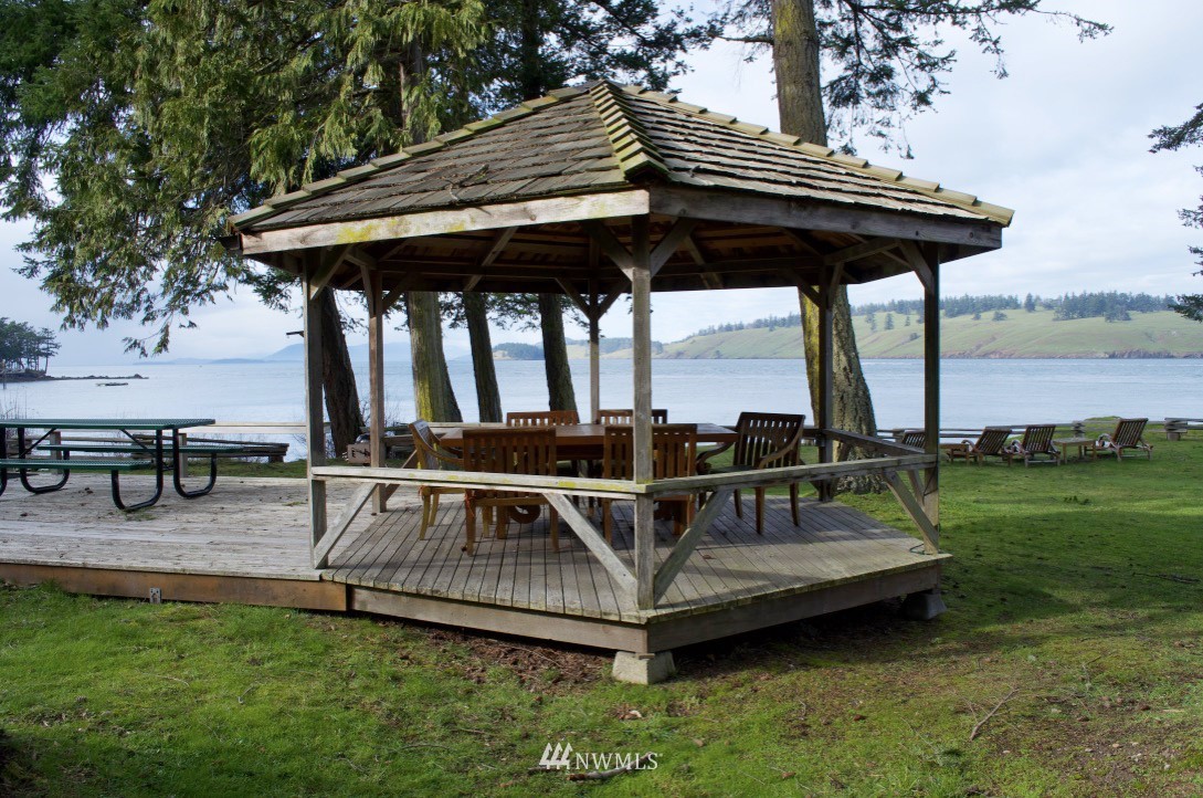 416 Lonesome Cove Road Friday Harbor, WA 98250 - Photo 32 of 40 a view of a chairs and table on the deck in front of house