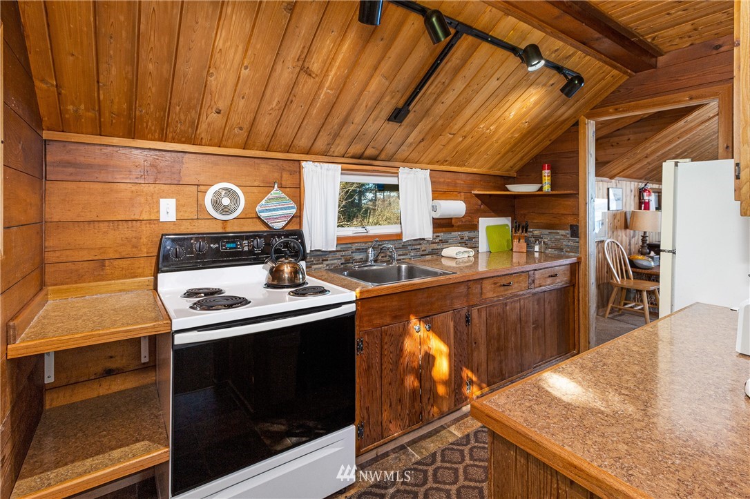 416 Lonesome Cove Road Friday Harbor, WA 98250 - Photo 9 of 40 a kitchen with a stove and cabinets