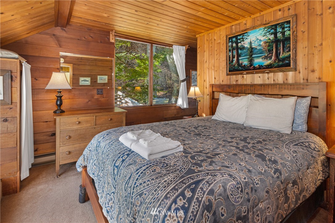 416 Lonesome Cove Road Friday Harbor, WA 98250 - Photo 10 of 40 a bedroom with a bed and a large window