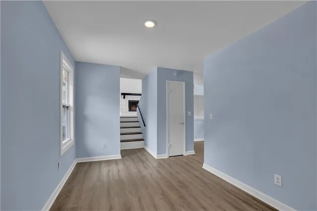 wooden floor in an empty room with a window