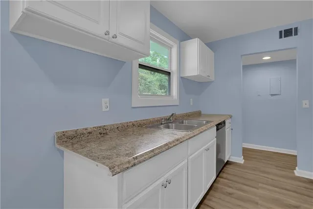 a kitchen with a stove and a window