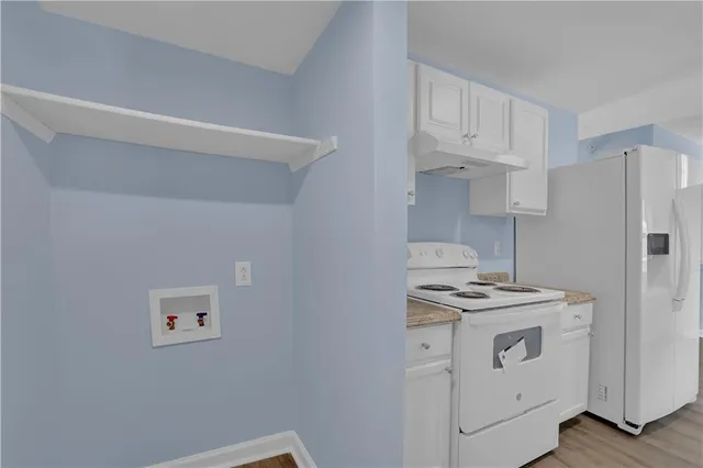 a kitchen with a stove and a refrigerator