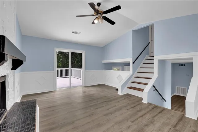 a view of entryway and hall with wooden floor