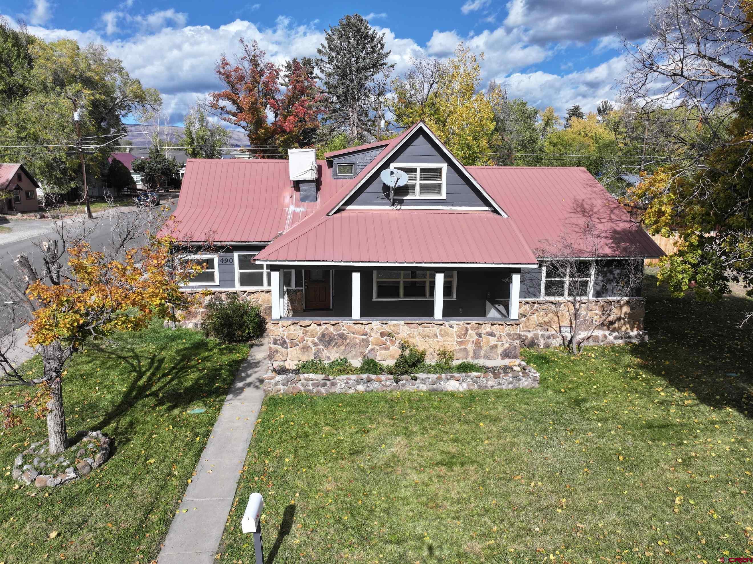 490 West Main Street Cedaredge, CO 81413 - Photo 1 of 31 a front view of a house with garden