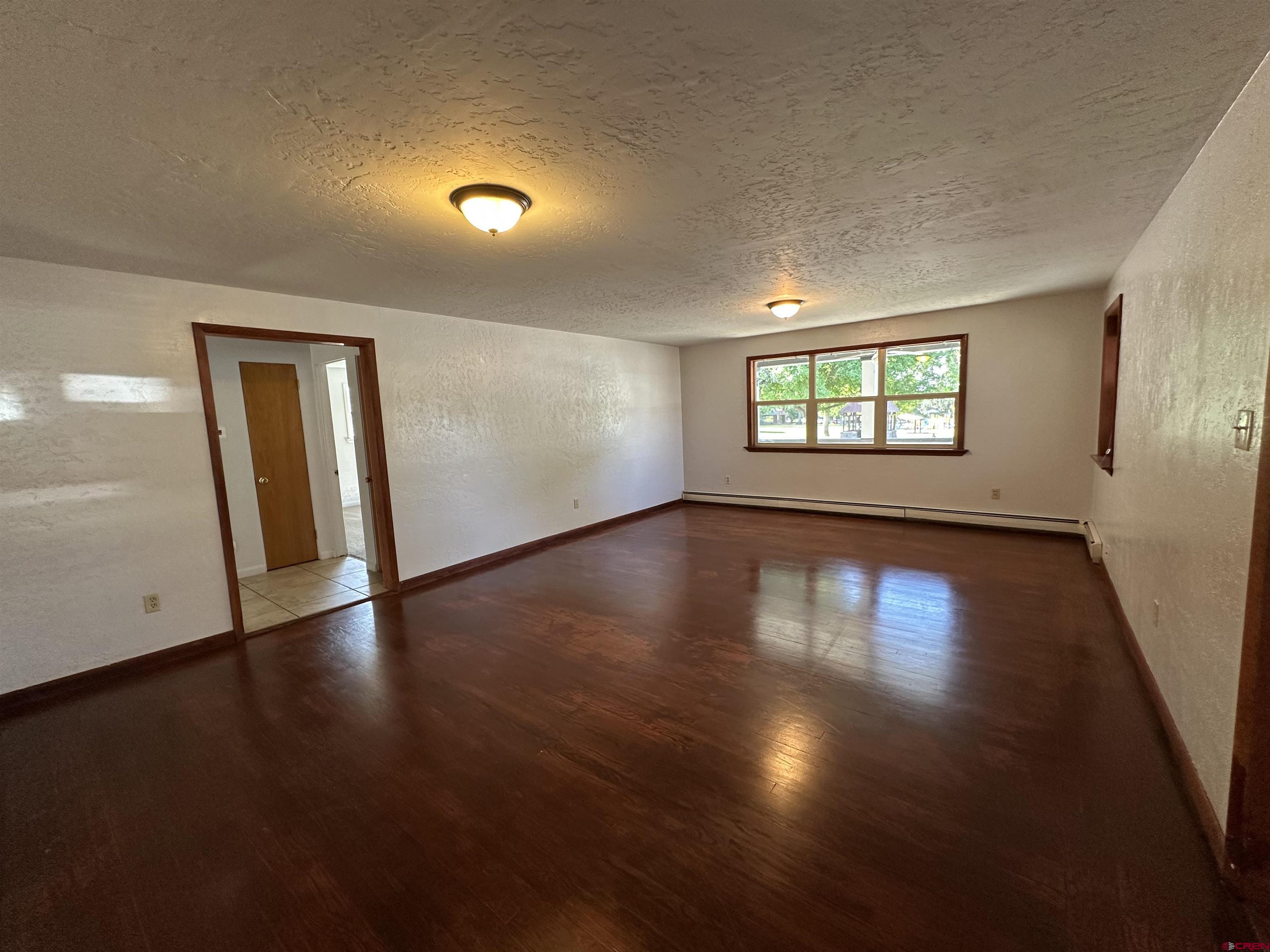 490 West Main Street Cedaredge, CO 81413 - Photo 16 of 31 a view of an empty room with wooden floor and a window