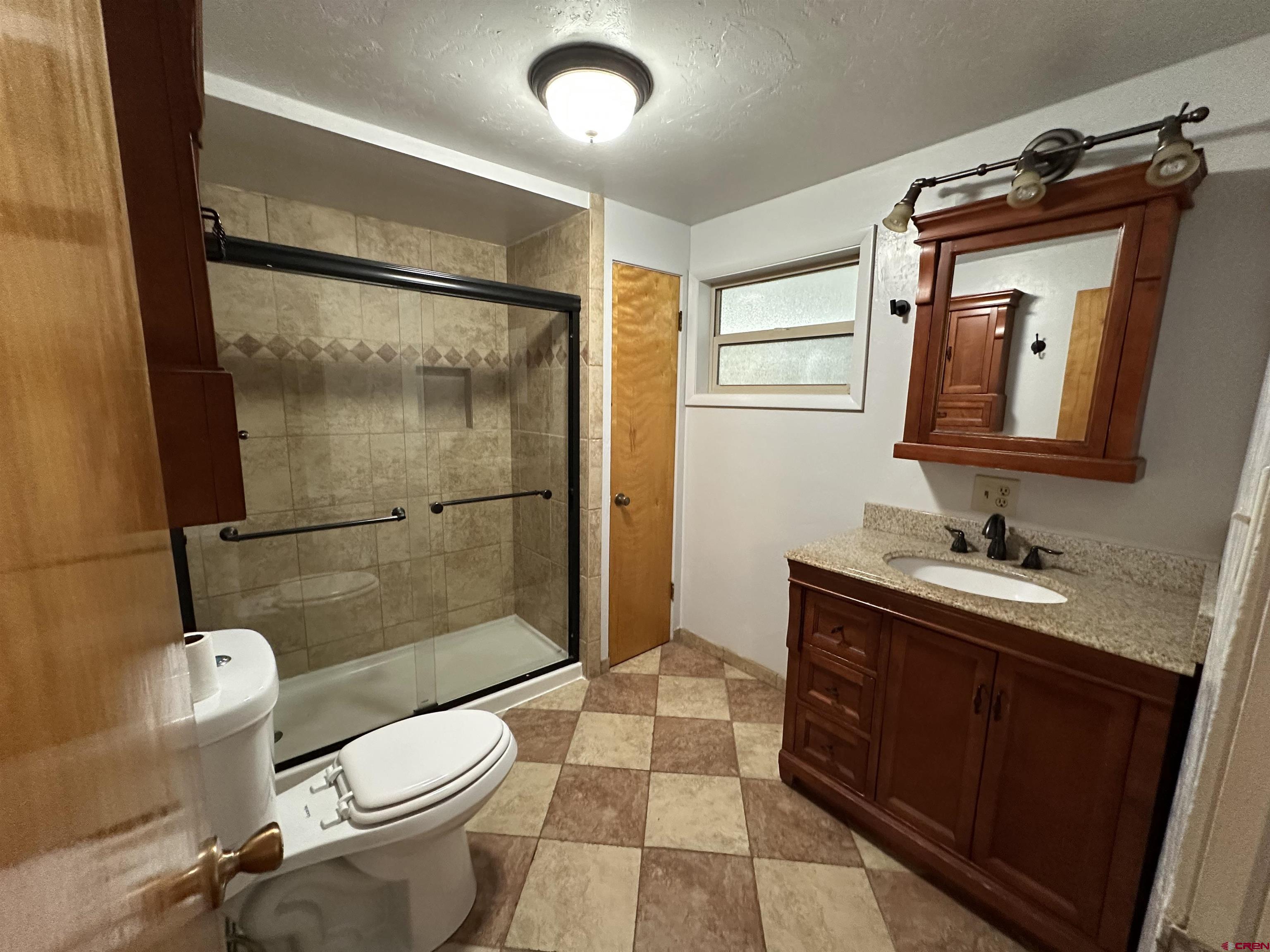 490 West Main Street Cedaredge, CO 81413 - Photo 18 of 31 a bathroom with a sink toilet and shower