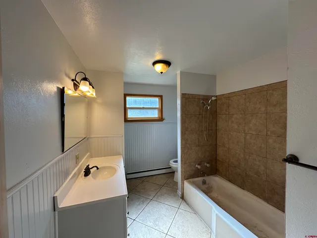 a bathroom with a sink tub and shower