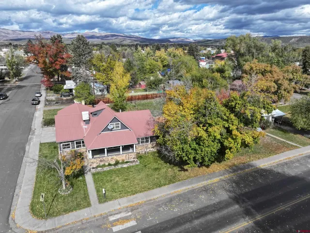 an aerial view of residential houses with outdoor space and street view