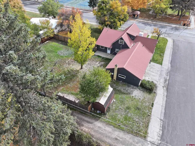 an aerial view of a house with garden space and street view