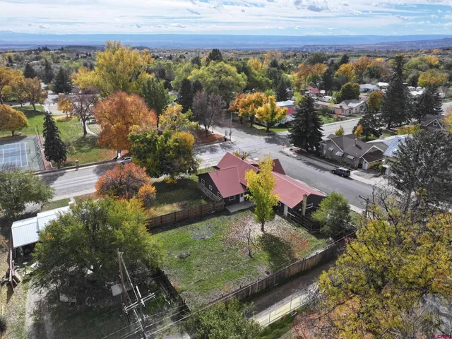 an aerial view of a house with a yard