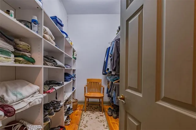 a living room with stainless steel appliances kitchen island granite countertop furniture wooden floor and a view of living room