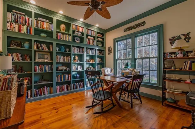 a view of a backyard with table and chairs and a large tree