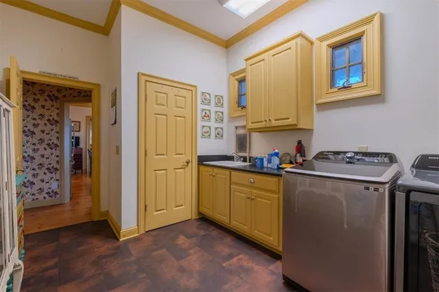 a view of a lake with a table and chairs under an umbrella