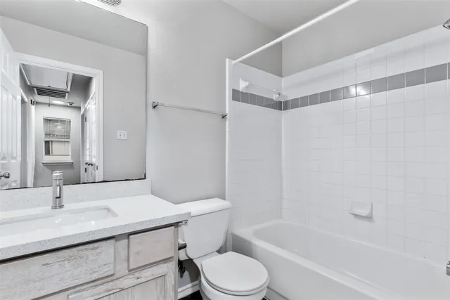 a bathroom with a sink toilet a mirror and shower