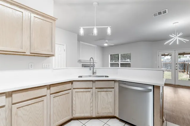 a kitchen with cabinets and window