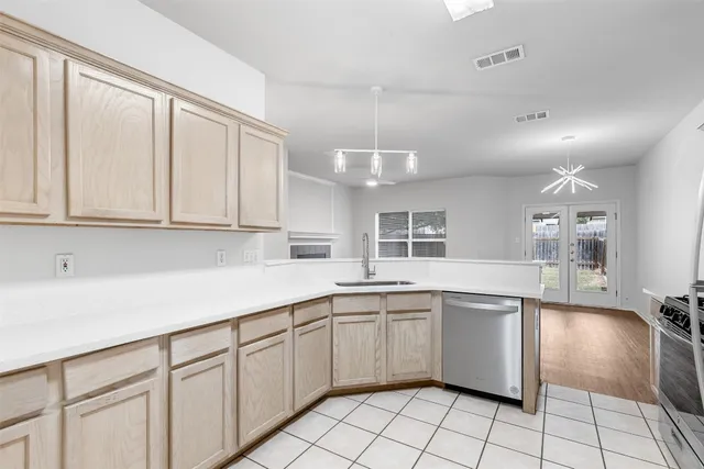 a kitchen with cabinets and sink