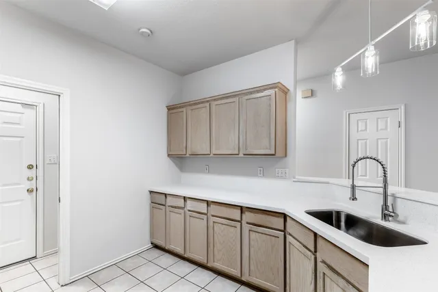 a kitchen with stainless steel appliances granite countertop a sink a stove and cabinets