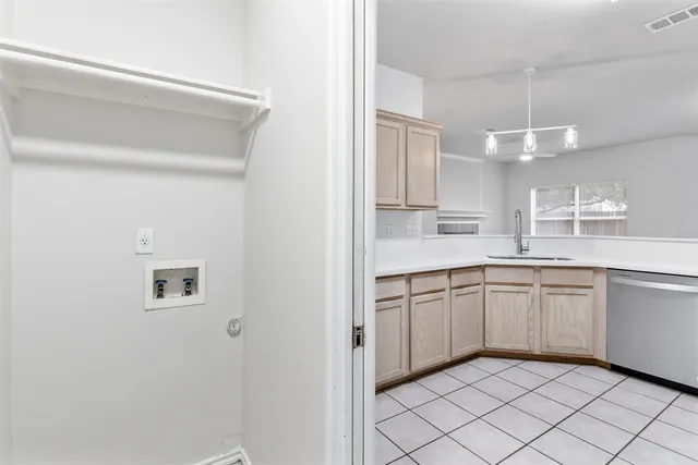 a kitchen with a cabinets and chandelier