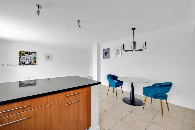 a kitchen with granite countertop a sink stainless steel appliances and cabinets