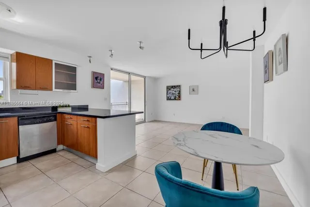a kitchen with stainless steel appliances granite countertop a sink and a refrigerator