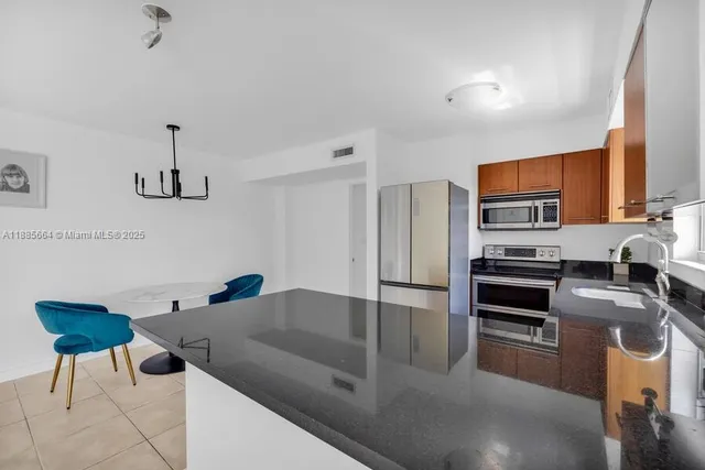 a bathroom with a granite countertop sink a toilet and bathtub