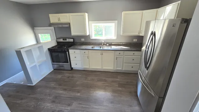 a kitchen with a refrigerator sink and stove