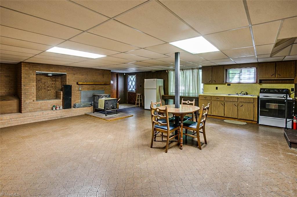 1896 Spero Road Asheboro, NC 27205 - Photo 19 of 29 Basement recreation room w/wood stove & kitchen area (not counted in sq footage- ceiling height less than 7')