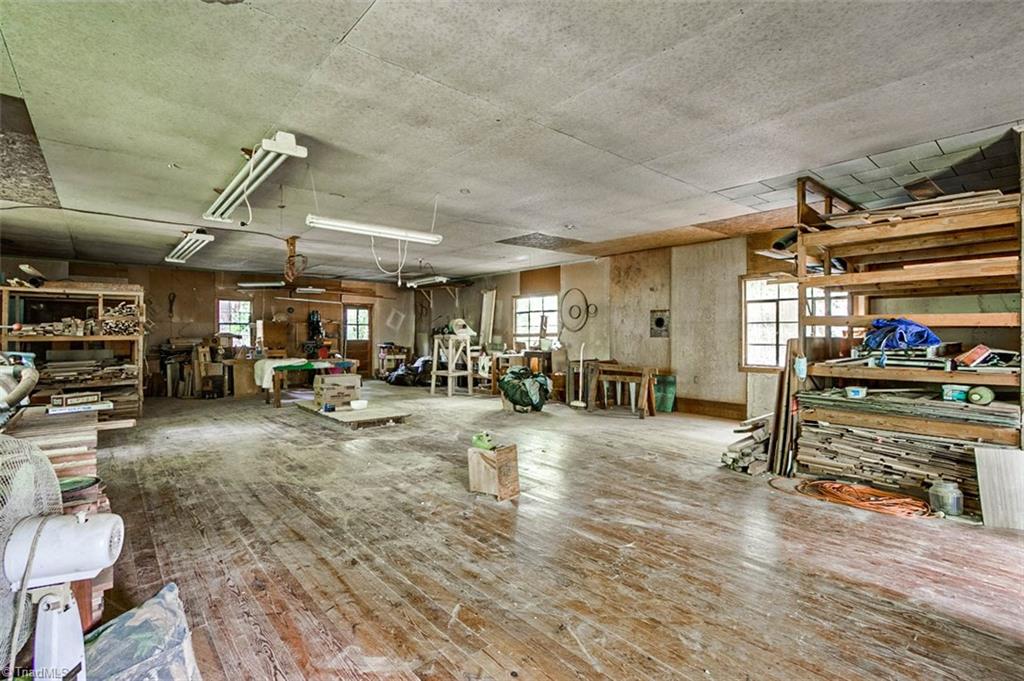 1896 Spero Road Asheboro, NC 27205 - Photo 28 of 29 Inside workshop, wood floors & flue for wood stove