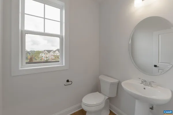 a bathroom with a toilet a sink and a mirror