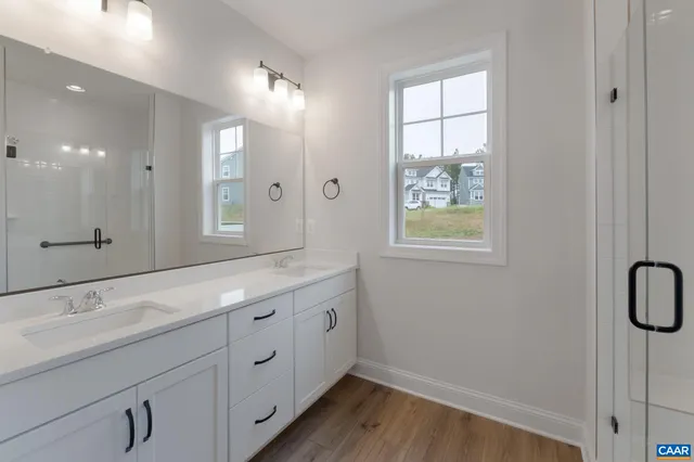 a bathroom with a double vanity sink and a mirror