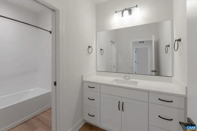 a bathroom with a shower and a sink