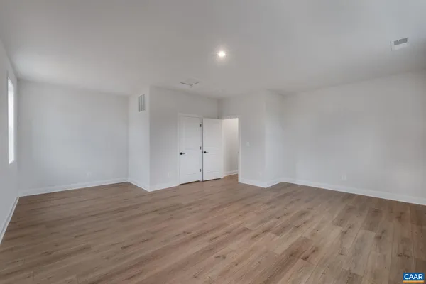 a view of an empty room and wooden floor
