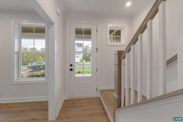 a view of an entryway with wooden floor and windows
