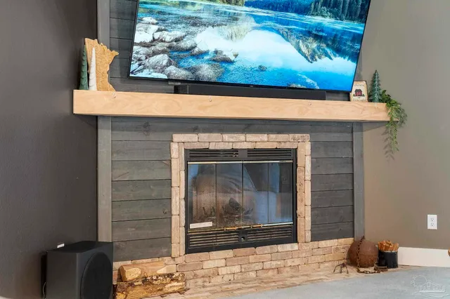 a bedroom with a large bed and a fireplace