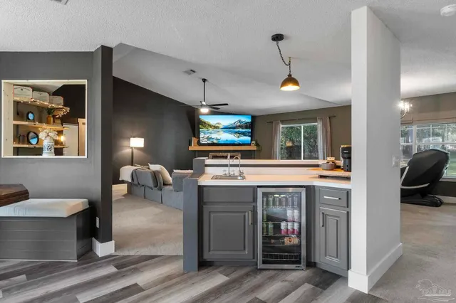 a kitchen with granite countertop a refrigerator stove top oven and sink