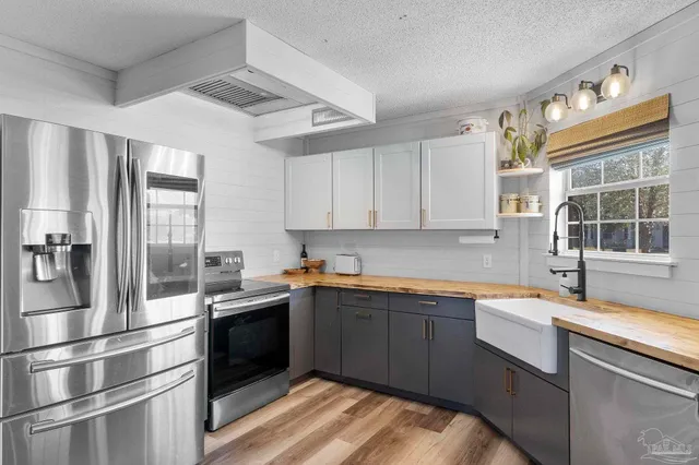 a kitchen with stainless steel appliances granite countertop a sink and a stove