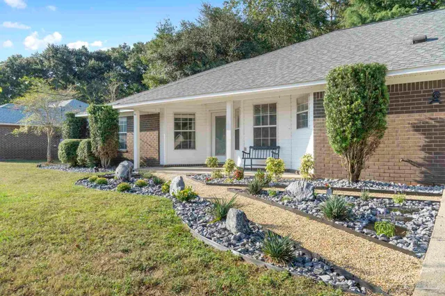 a front view of a house with garden