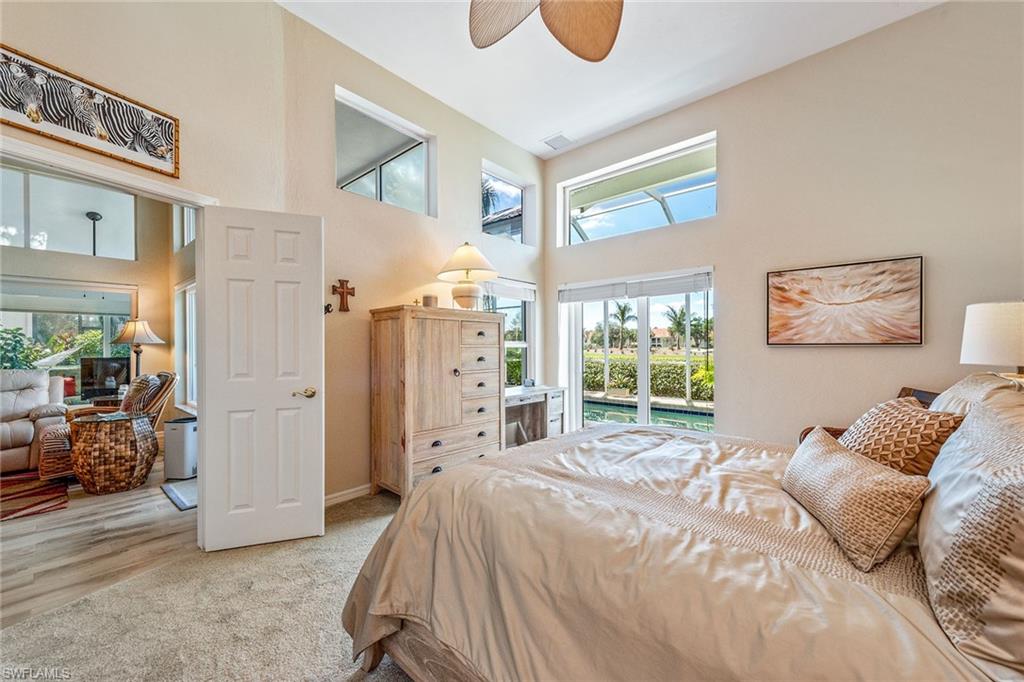 116 Napa Ridge Way Naples, FL 34119 - Photo 11 of 28 a spacious bedroom with a bed a couch and a window