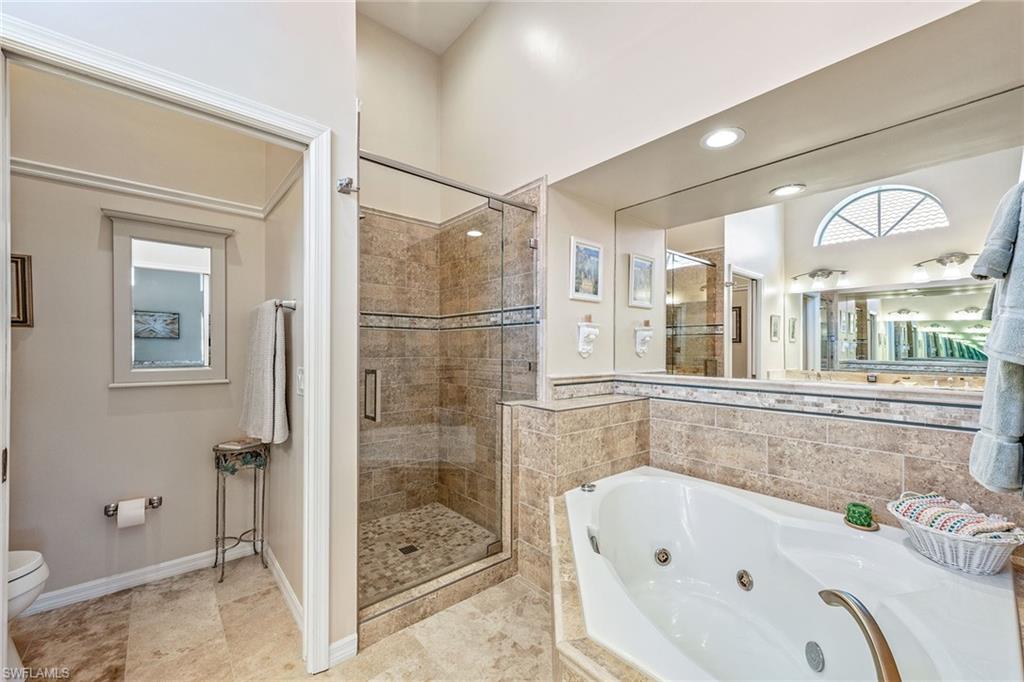 116 Napa Ridge Way Naples, FL 34119 - Photo 13 of 28 a bathroom with a bathtub and a shower