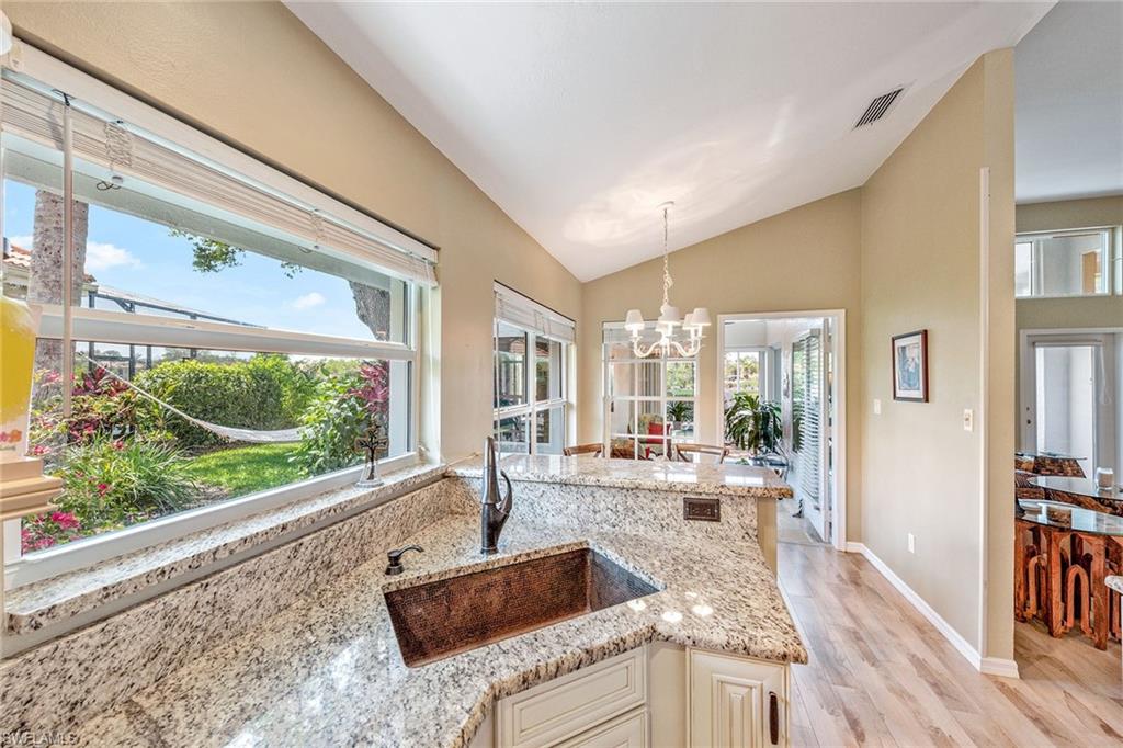 116 Napa Ridge Way Naples, FL 34119 - Photo 7 of 28 a living room with furniture large window and wooden floor