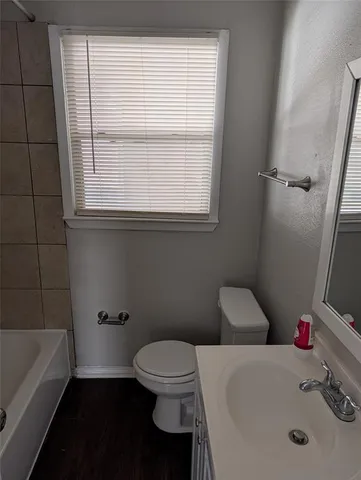 a bathroom with a sink a toilet and tub